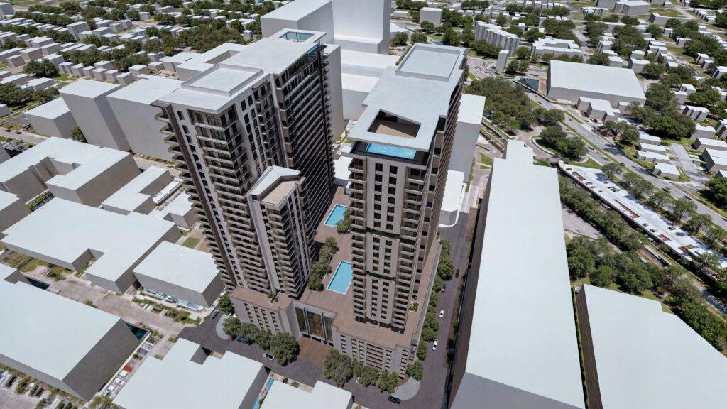 Aerial view of Merrick Parc's modern high-rise towers with rooftop pools in an urban setting.