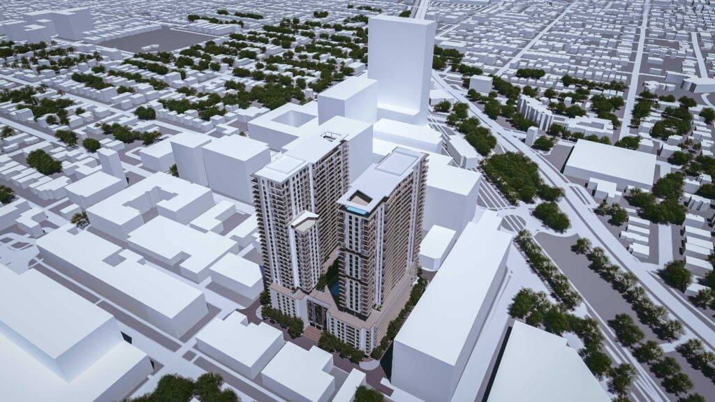 Aerial view of Merrick Parc, a modern architectural development with sleek high-rise buildings located in a bustling urban setting.