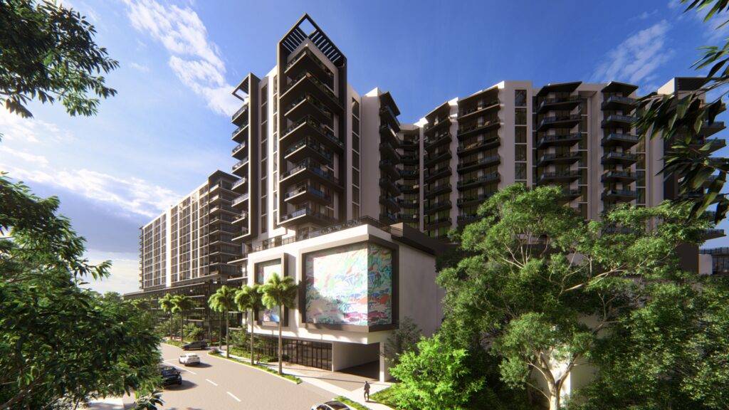 Modern high-rise building surrounded by lush greenery on a sunny day.