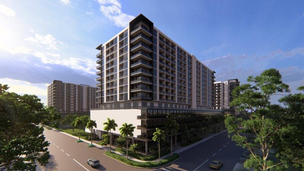 Modern apartment buildings surrounded by lush greenery under a bright blue sky.