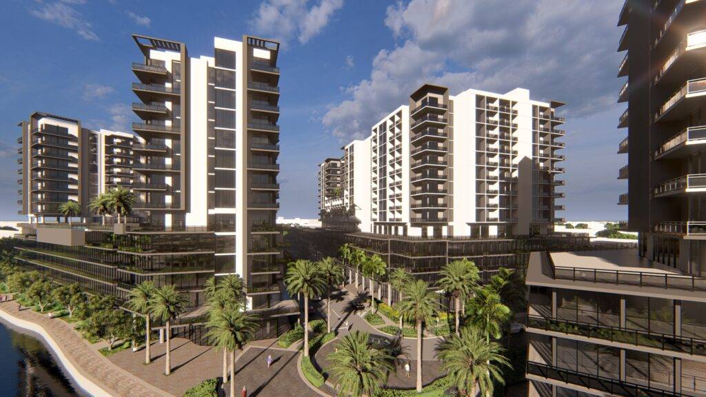 Modern apartment buildings with balconies, surrounded by palm trees under a clear blue sky.