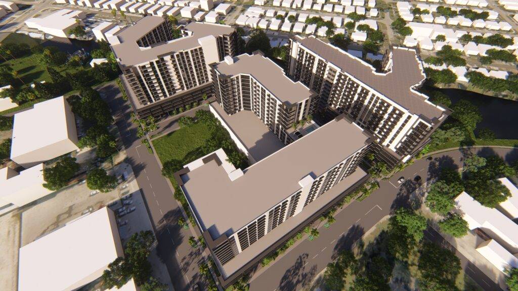 Aerial view of modern apartment complex surrounded by greenery and urban landscape.