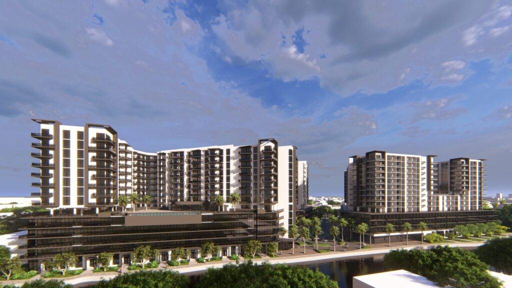 Modern apartment complex with lush greenery under a vibrant sky