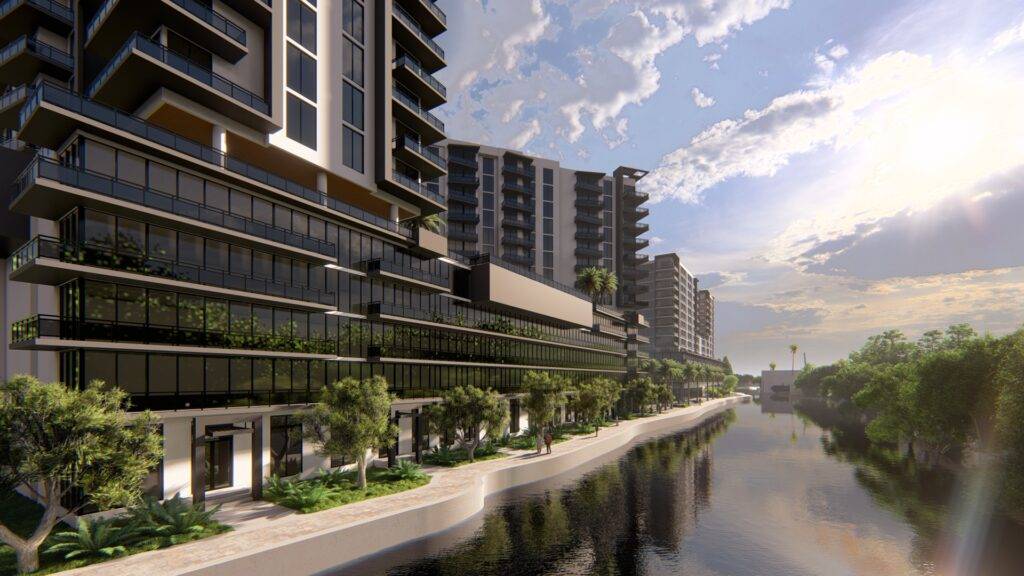 Modern riverside apartments with lush greenery.