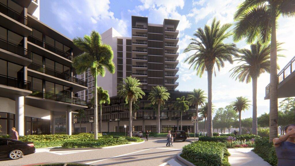 Modern residential buildings amidst tall palm trees under a bright blue sky.