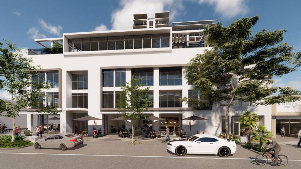 Modern mixed-use building with retail spaces and parked cars in an urban setting.