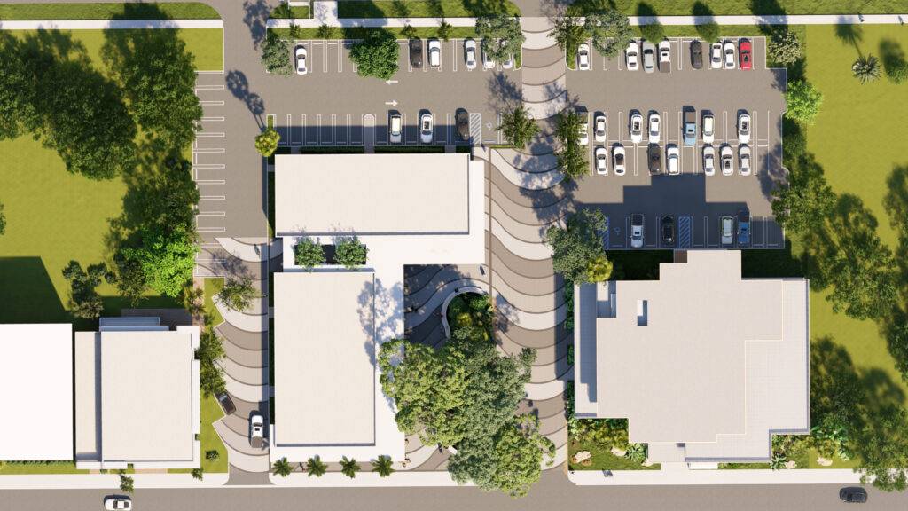 Aerial rendering of a modern architectural complex with landscaped surroundings and parking spaces.