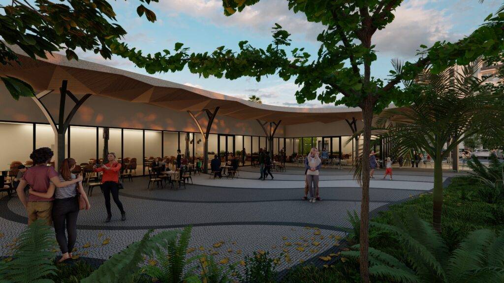 Evening view of a modern outdoor pavilion with people enjoying a relaxed atmosphere under a canopy.