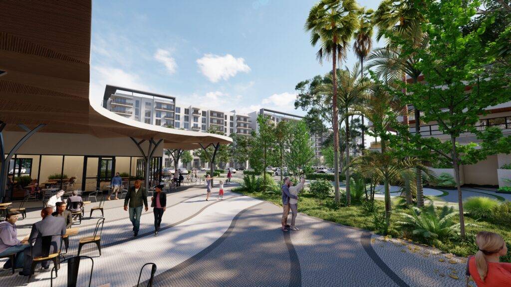 Modern urban park with people strolling under clear skies, surrounded by lush greenery and contemporary buildings.