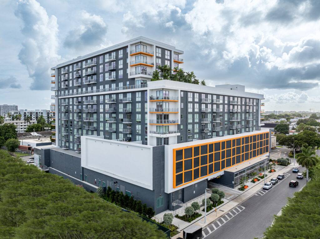 Modern high-rise building in Allapattah under a cloudy sky.