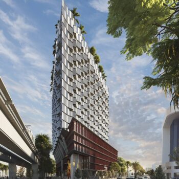 Modern urban skyscraper with unique architecture and lush greenery accents against a blue sky.