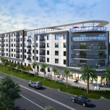 Modern apartment building with palm trees and a busy street.