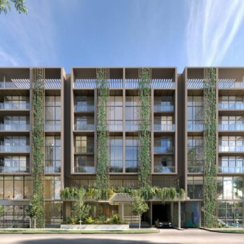 Modern eco-friendly apartment building with lush greenery.