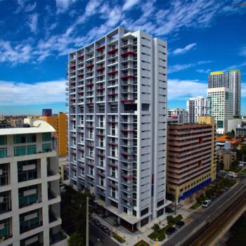 Urban skyline with modern high-rise buildings under a vibrant blue sky in Brickell.