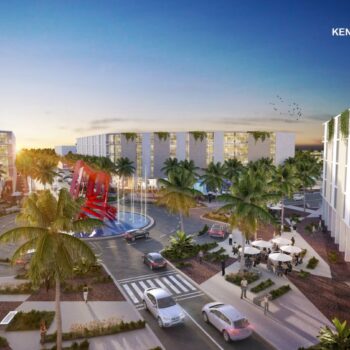 Aerial view of Kendall Town Center at sunset, featuring lush greenery, modern buildings, and palm-lined streets.