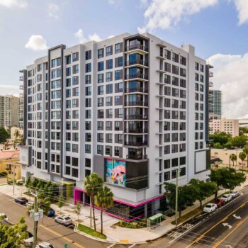 Modern city apartment building with vibrant street view and urban surroundings.