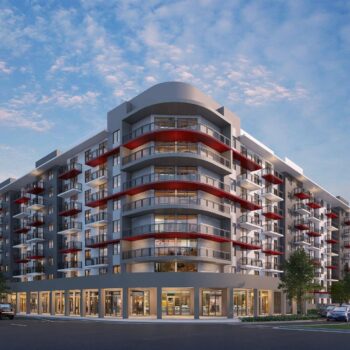 Modern multi-story building with red balconies under a vibrant sunset sky