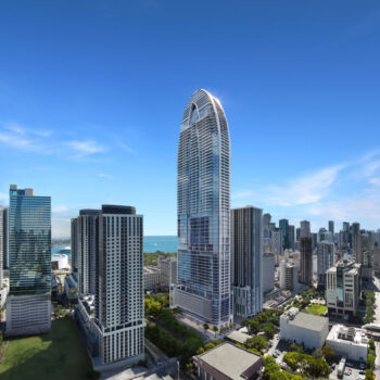 Modern skyline with a striking, futuristic skyscraper under a clear blue sky.