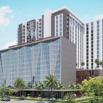 Modern urban apartment building with glass facade and palm trees.