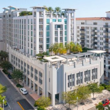 Modern urban architecture with towering buildings and lush greenery.