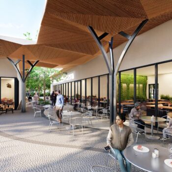 Modern outdoor café with wooden ceilings and patrons enjoying refreshments.