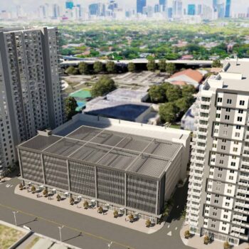 Aerial view of modern high-rise apartments with city skyline in the background.